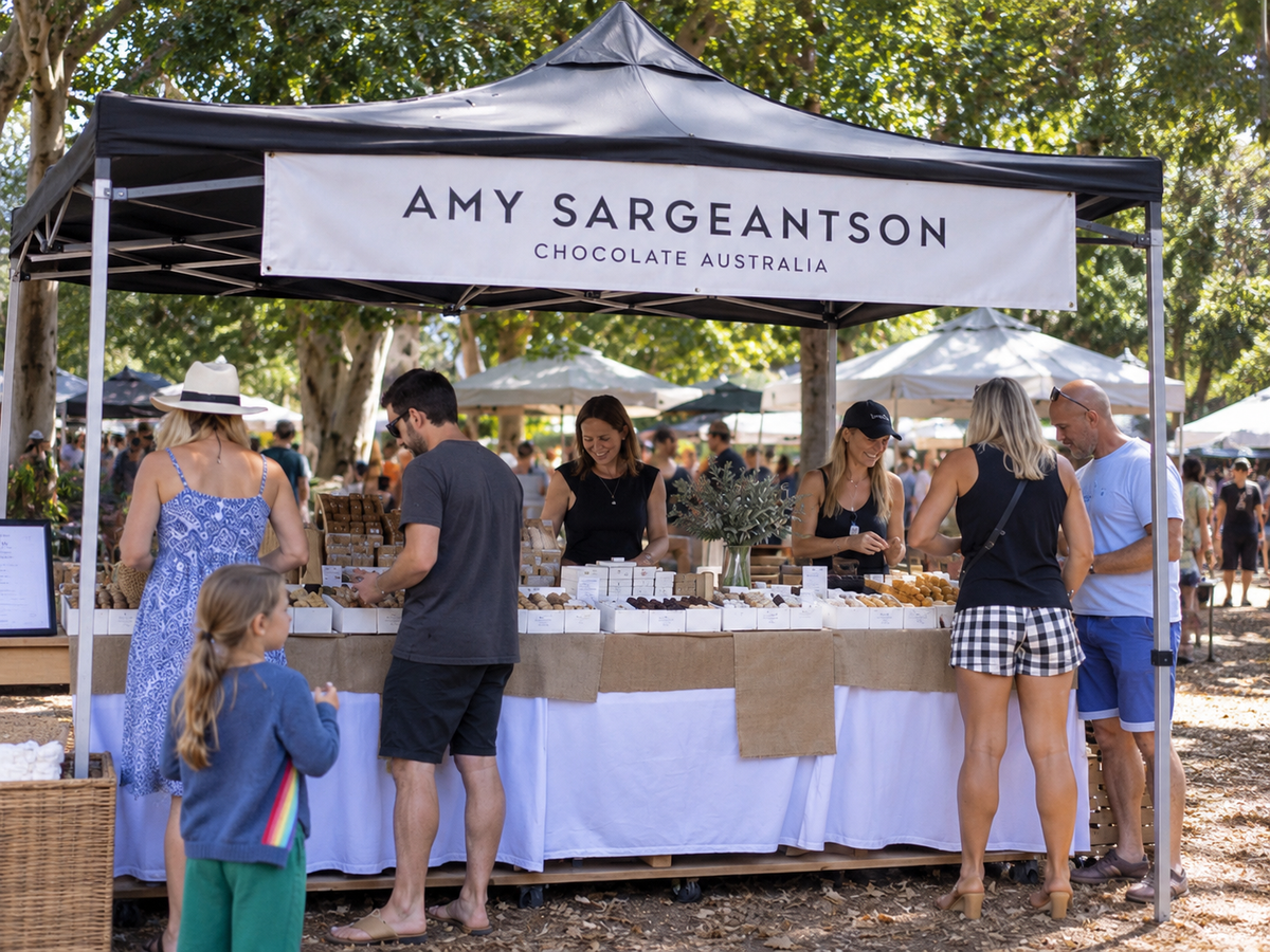Natural documentary-style photograph of Amy Sargeantson chocolate stall at Northey Street Markets